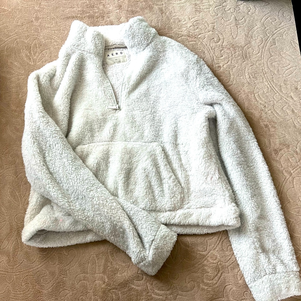 White soft and fluffy sweater.